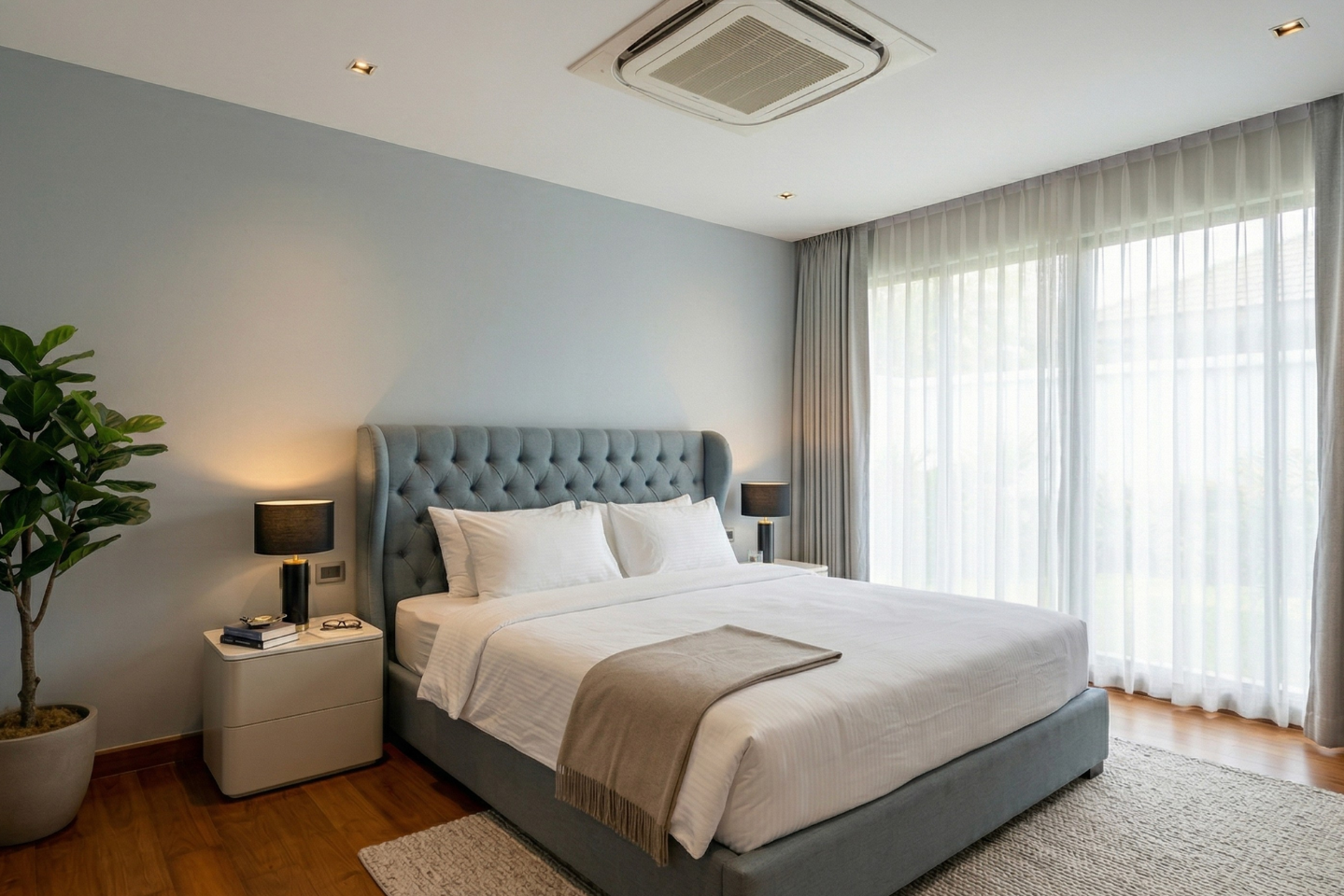 Villa Luma Botanica bedroom with blue tufted headboard and natural light