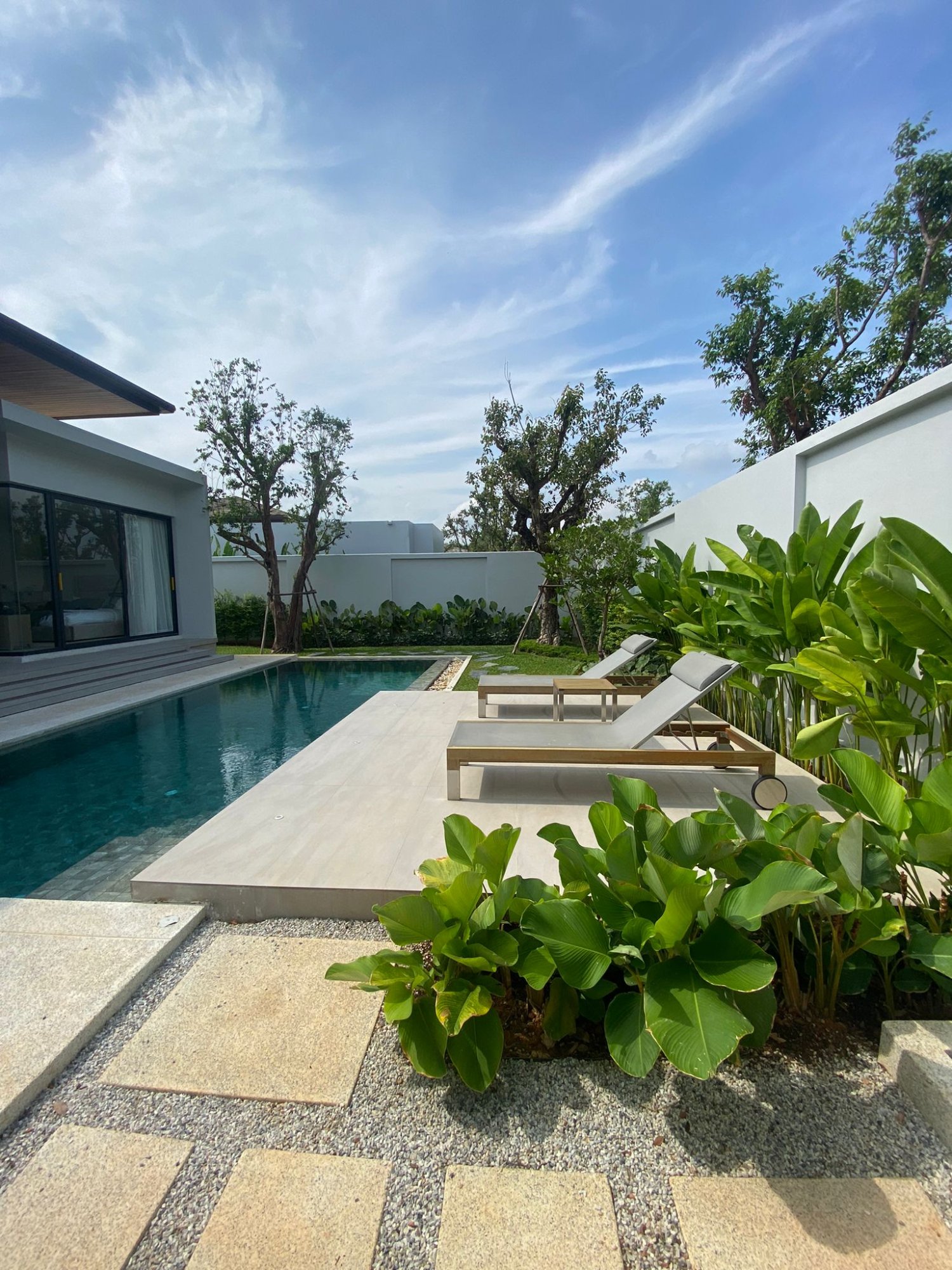 Villa Luma Botanica master bedroom with king-size bed and direct views of pool and garden