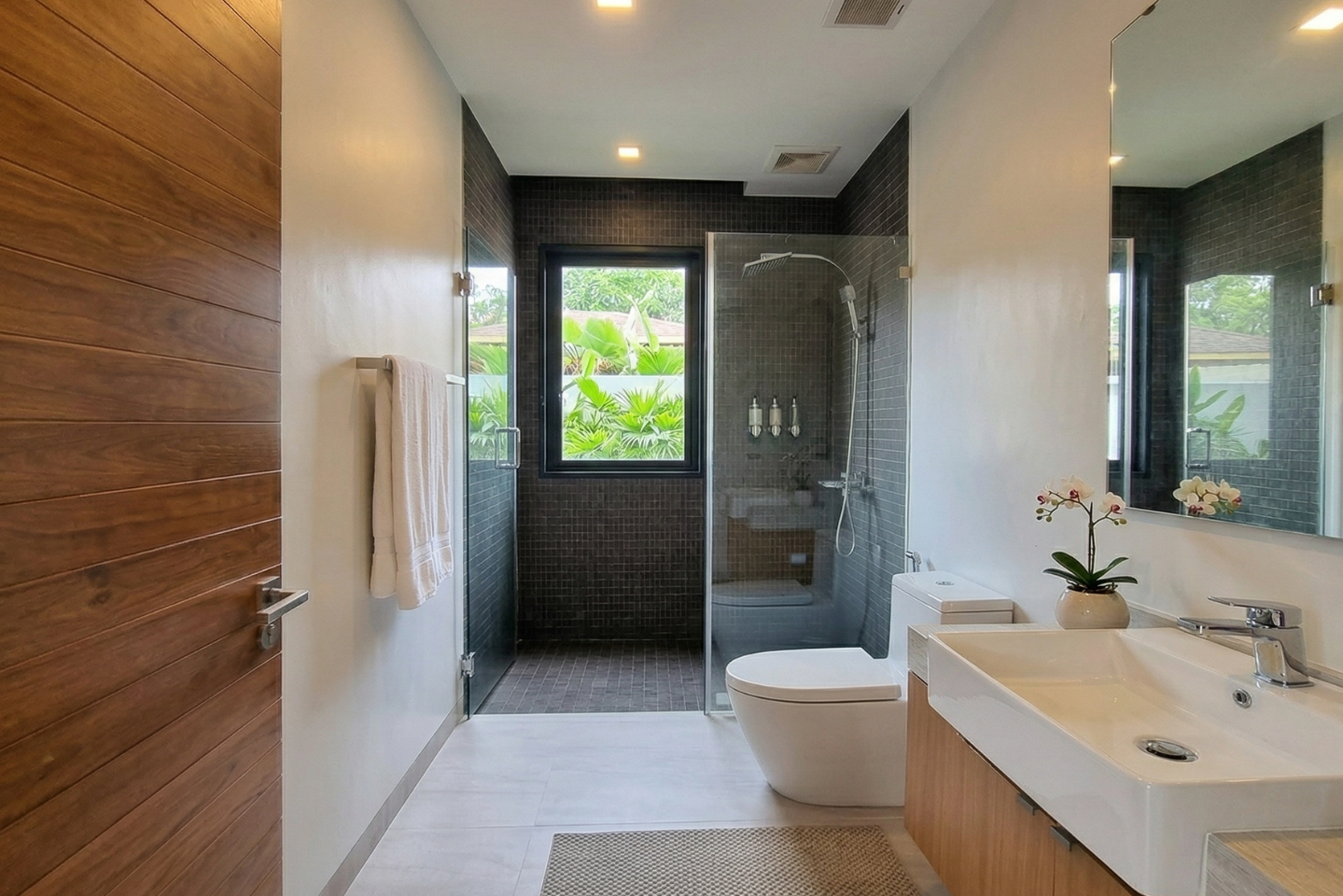 Villa Luma Botanica modern bathroom with rain shower and timber accents
