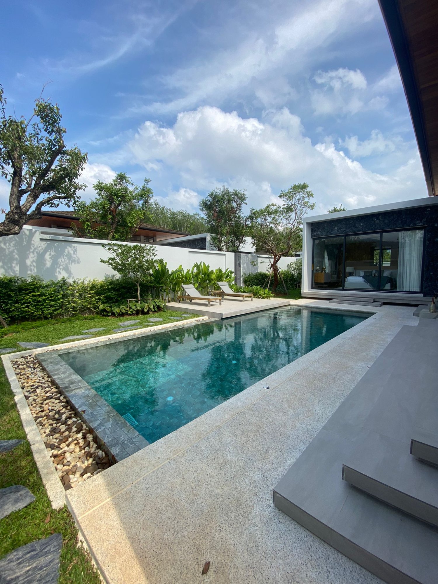 Villa Luma Botanica tropical garden with frangipani tree and heliconia plants, Phuket